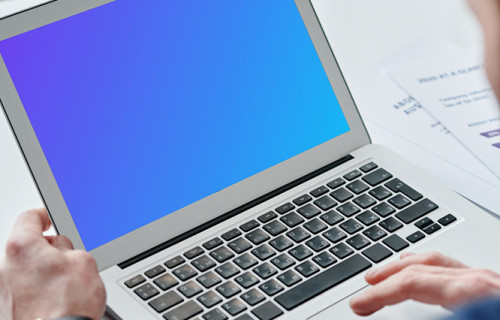 Person holding a MacBook Air mockup