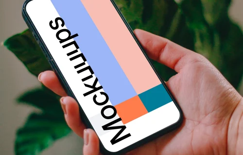 Person holding an iPhone 13 mockup