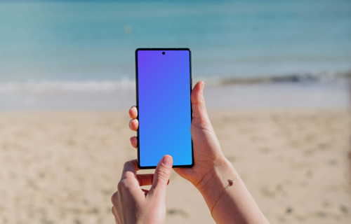 Pixel 6 mockup held by a user on a beach
