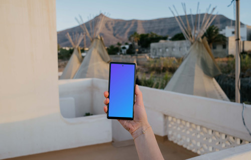 Pixel 6 mockup held in on a balcony
