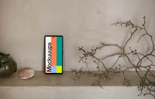 Pixel 6 mockup next to a teapot and plant