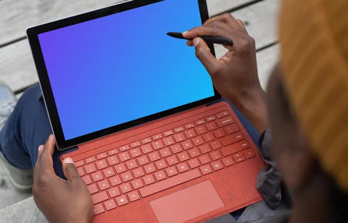 Red Microsoft Surface Laptop mockup held in a users lap