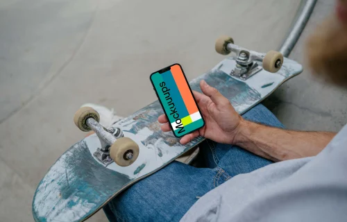 Skateboarder holding a smartphone mockup