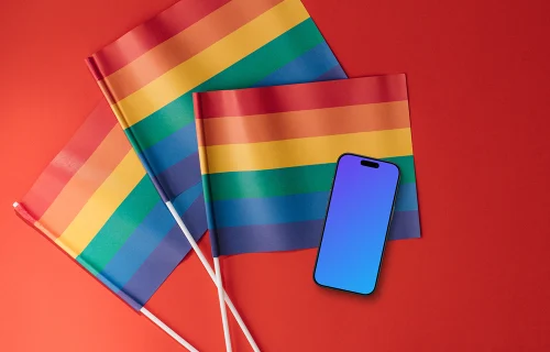 Smartphone mockup atop three rainbow flags