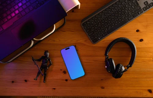 Smartphone mockup on a gamer's desk with action figure