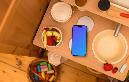 Smartphone mockup on a kid's creative table