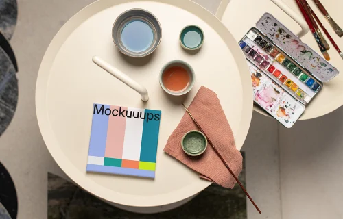 Square poster mockup with colorful palette and brushes