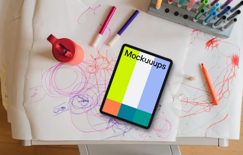 Tablet mockup on a child's drawing table