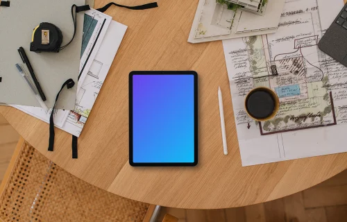 Tablet mockup on architect's desk with plans and tools