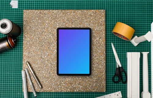 Tablet mockup on architects workspace with tools
