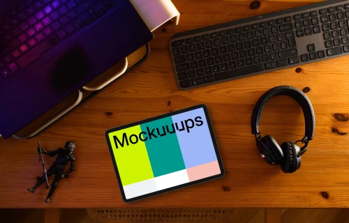 Tablet mockup on wooden desk with creative gadgets