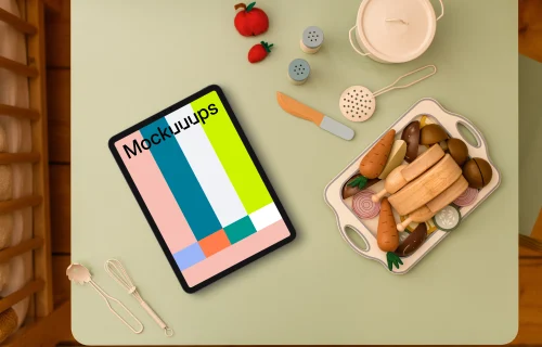 Tablet mockup surrounded by children’s play kitchen set