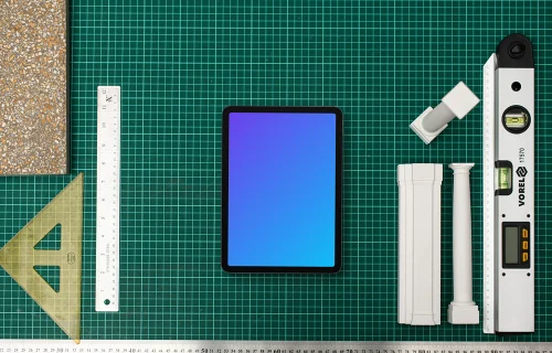 Tablet mockup with architect's tools on drafting table