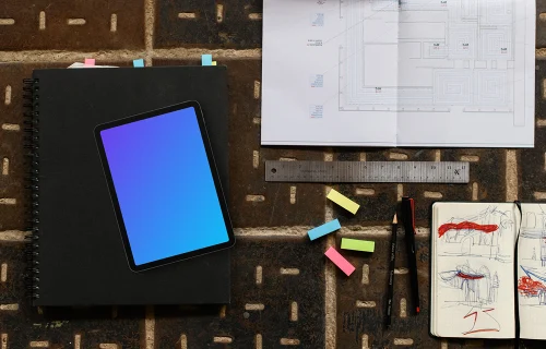 Tablet mockup with architectural blueprint and sketchbook