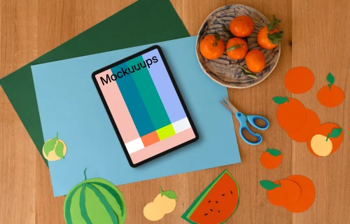 Tablet mockup with colorful fruit paper cutouts for kids