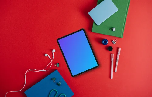 Tablet mockup with pencils and notebook on the side