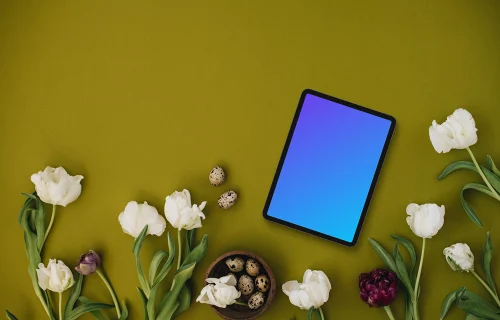 Tablet mockup with tulips on green background