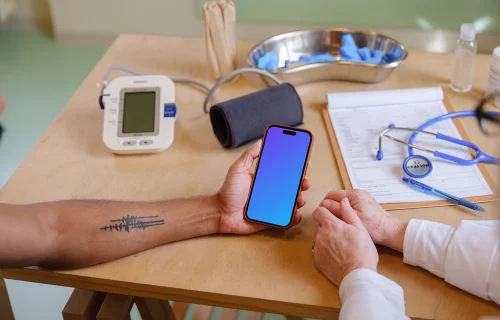 The patient holding a iPhone mockup in doctor’s office
