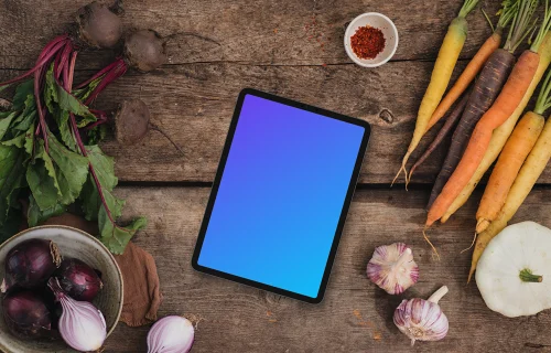 Top view of tablet mockup on wooden desk