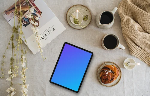 Top view of tablet mockup with a magazine on the side