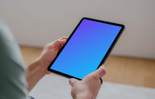 User holding an iPad Air mockup