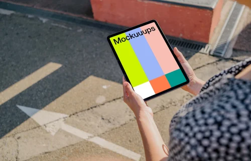 User holding an iPad Air mockup