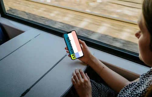 Woman hand holding an iPhone 13 mockup