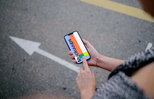 Woman hand pointing on an iPhone 13 mockup