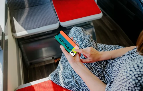 Woman hand typing on an iPhone 13 mockup