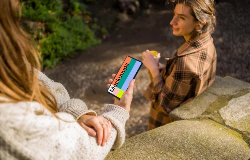 Woman holding a Google Pixel 6 next to a friend mockup