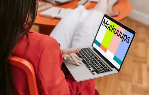 Woman holding a MacBook Pro mockup