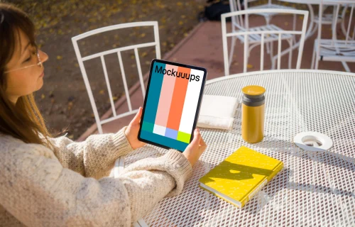 Woman holding an iPad mockup