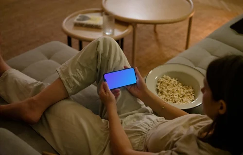 Woman holding an iPhone mockup