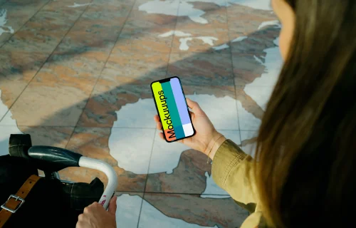 Woman holding iPhone 13 mockup at the airport