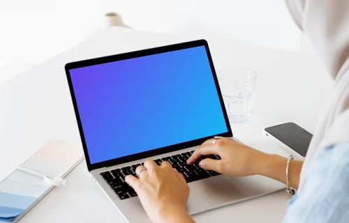 Woman typing on a MacBook Pro mockup