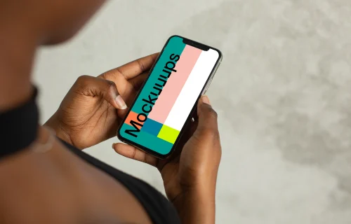 Young lady holding an iPhone 12 mockup