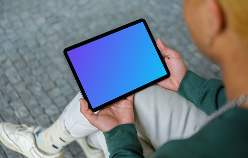 Young man holding iPad mockup
