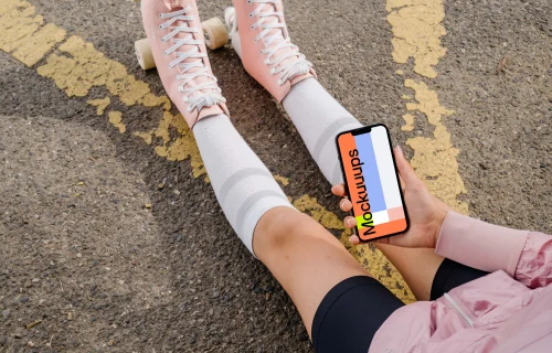 Young woman holding a phone mockup