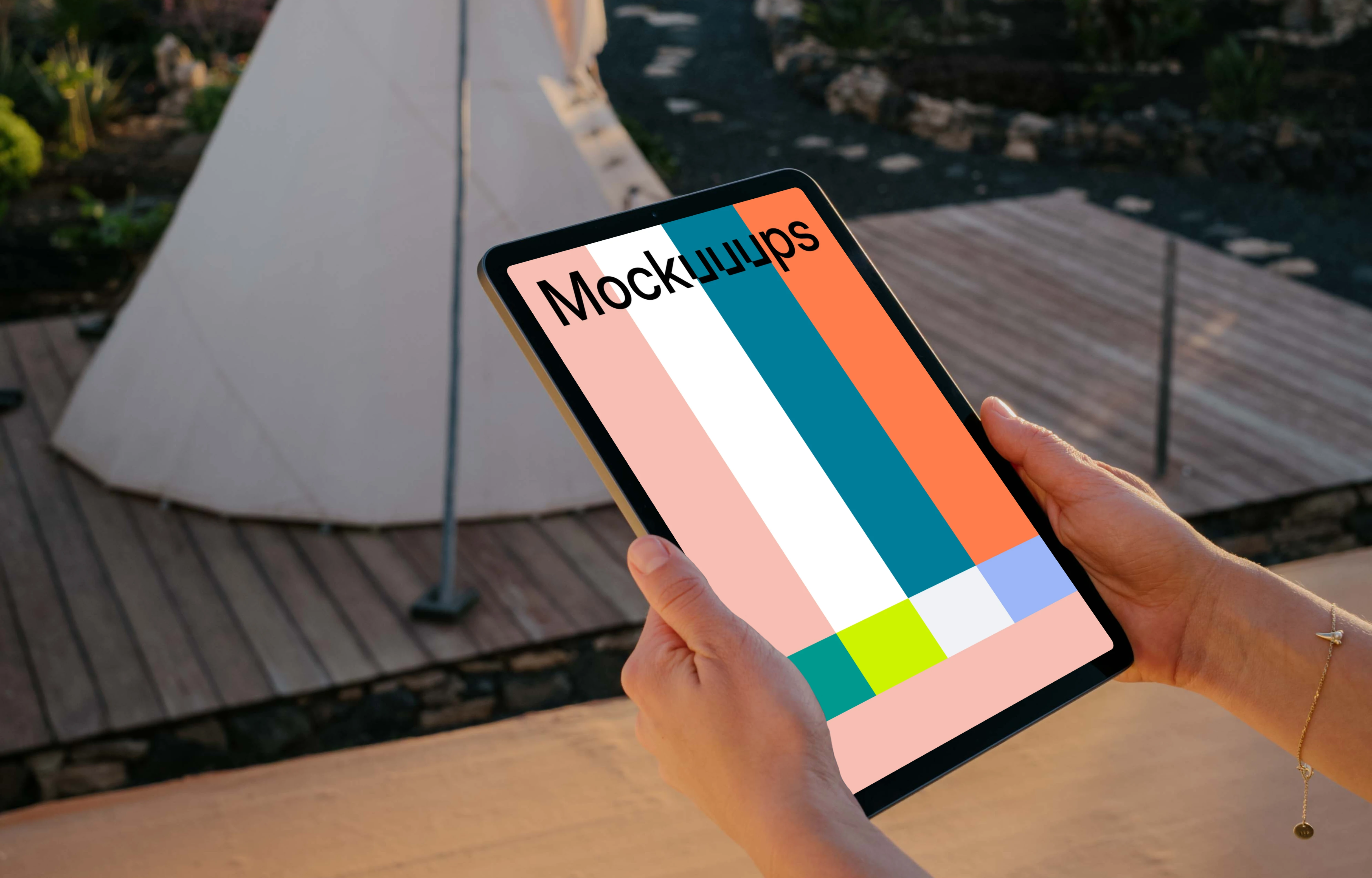 iPad Air mockup held by user on a patio