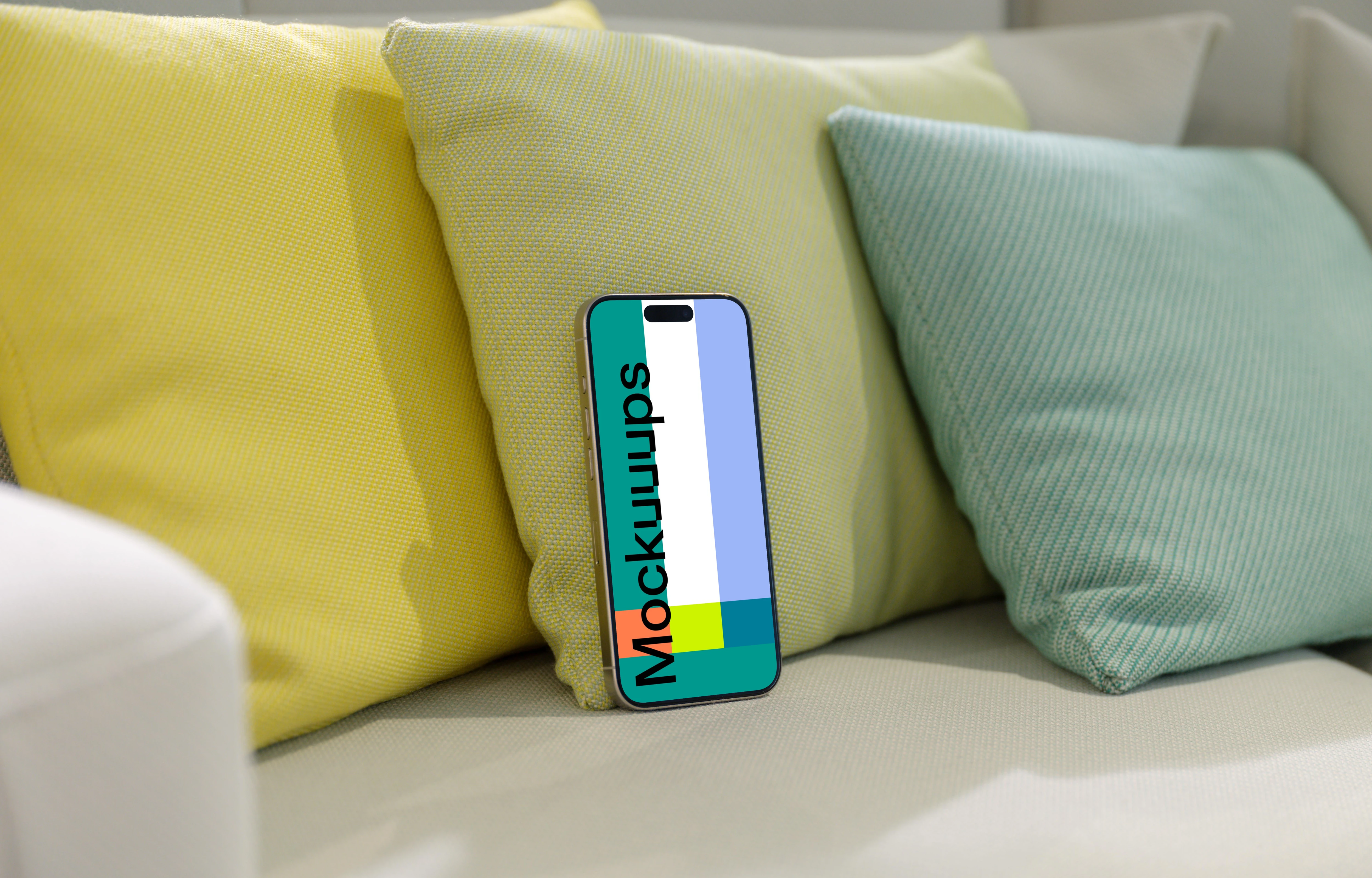 iPhone 15 Pro mockup on a cozy sofa with colorful cushions