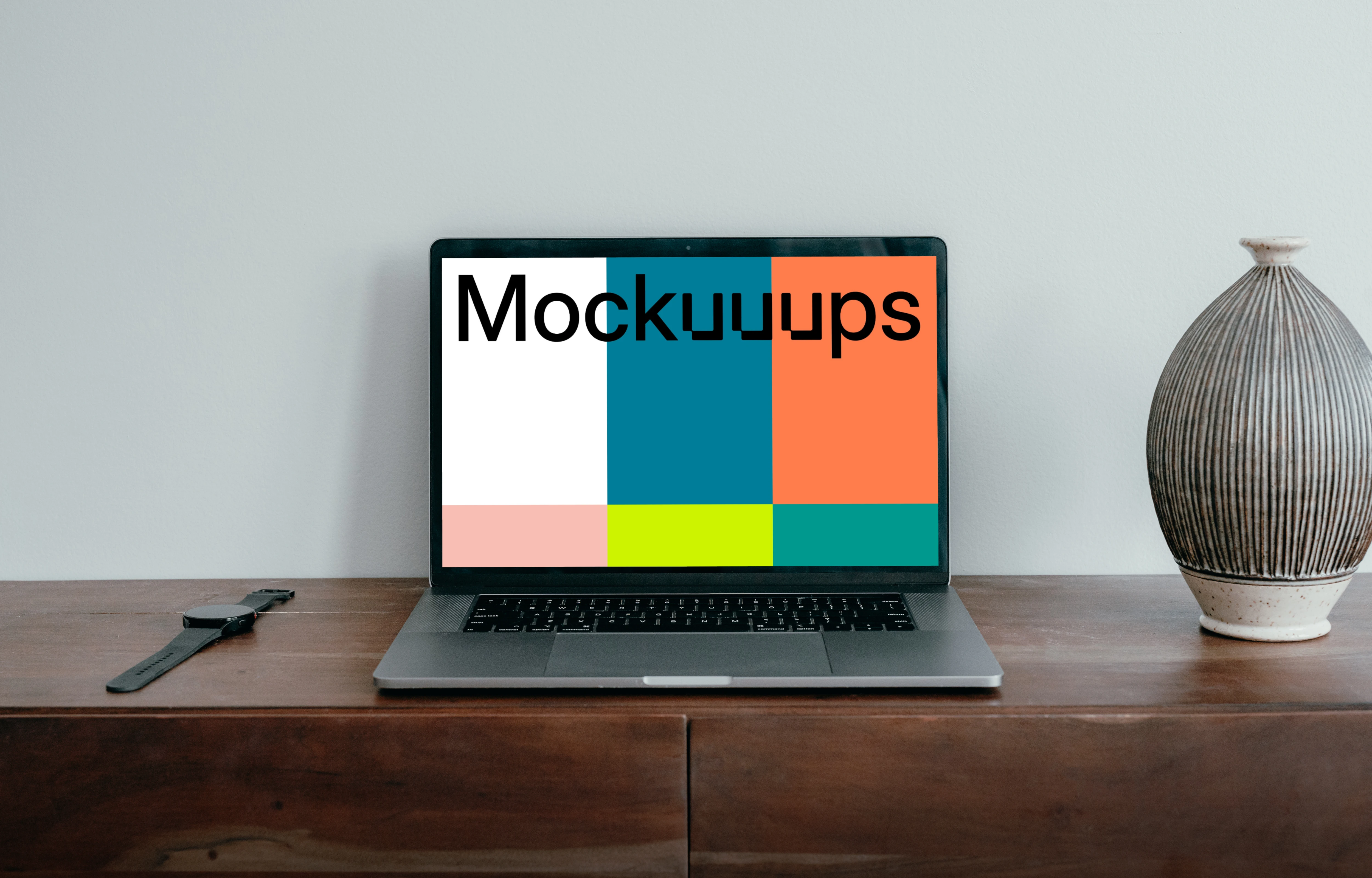 MacBook Pro mockup placed next to a vase and a knife