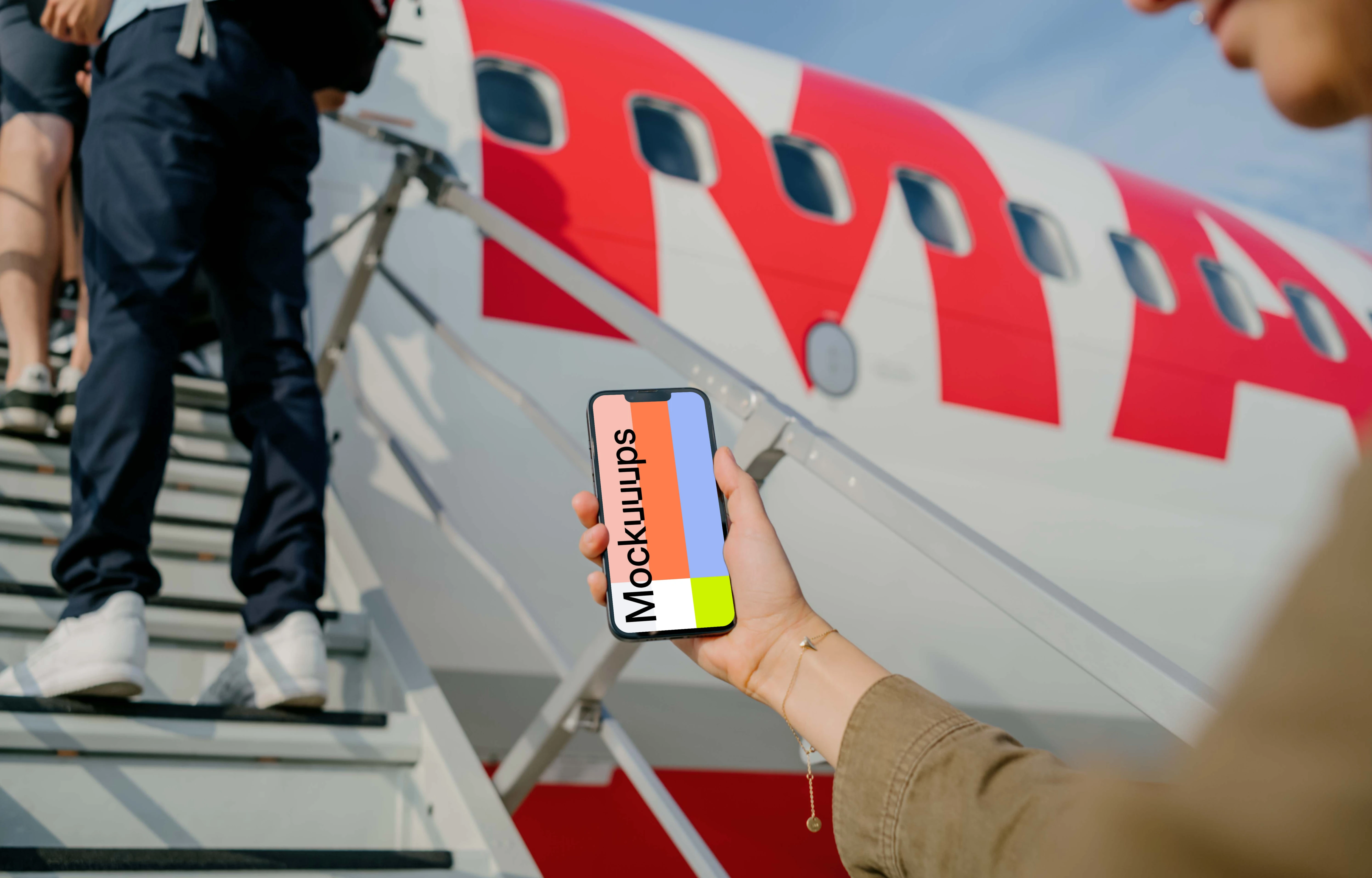 Man looking at an iPhone 13 mockup
