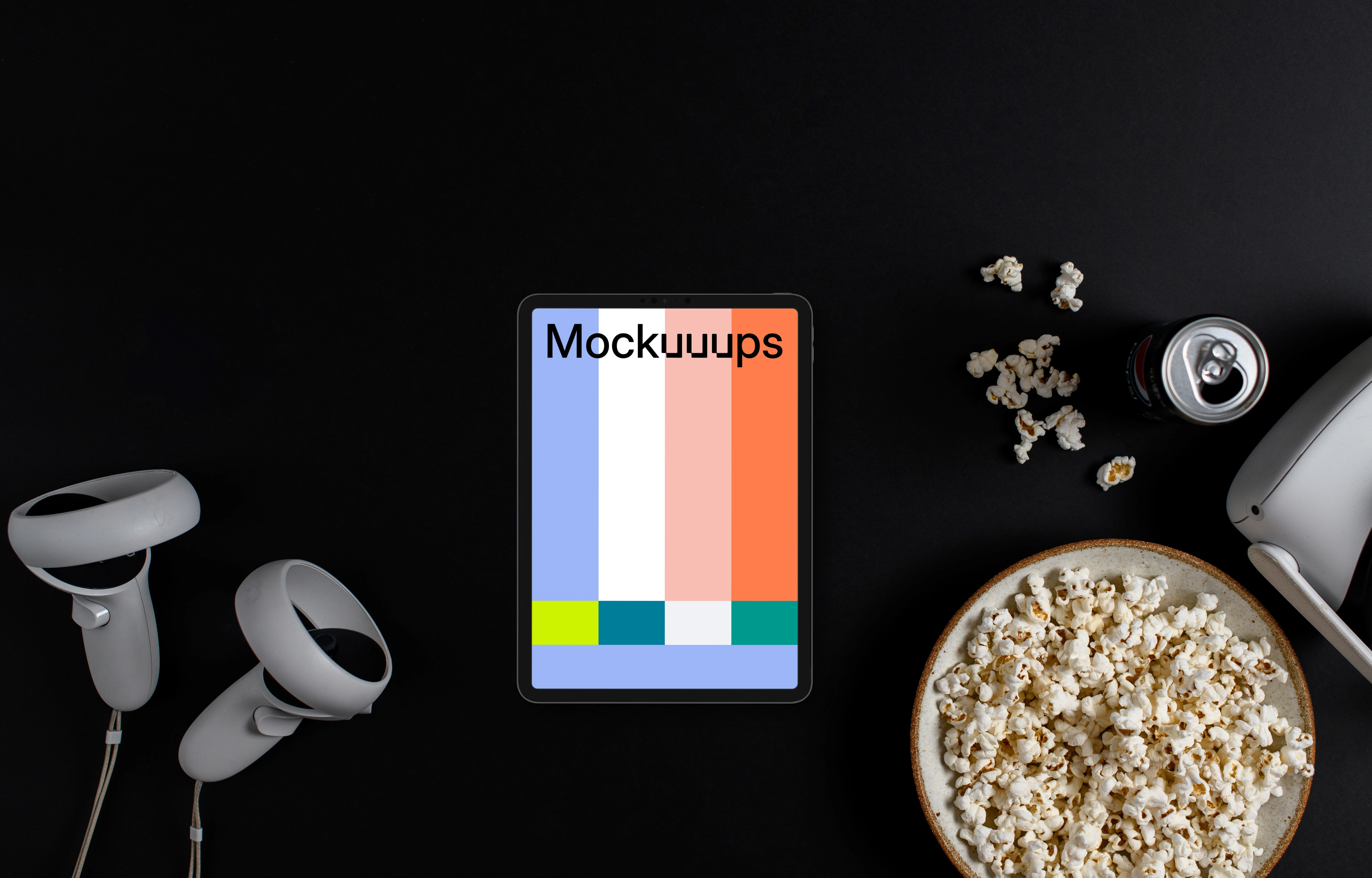 Tablet mockup with entertainment accessories on a dark background
