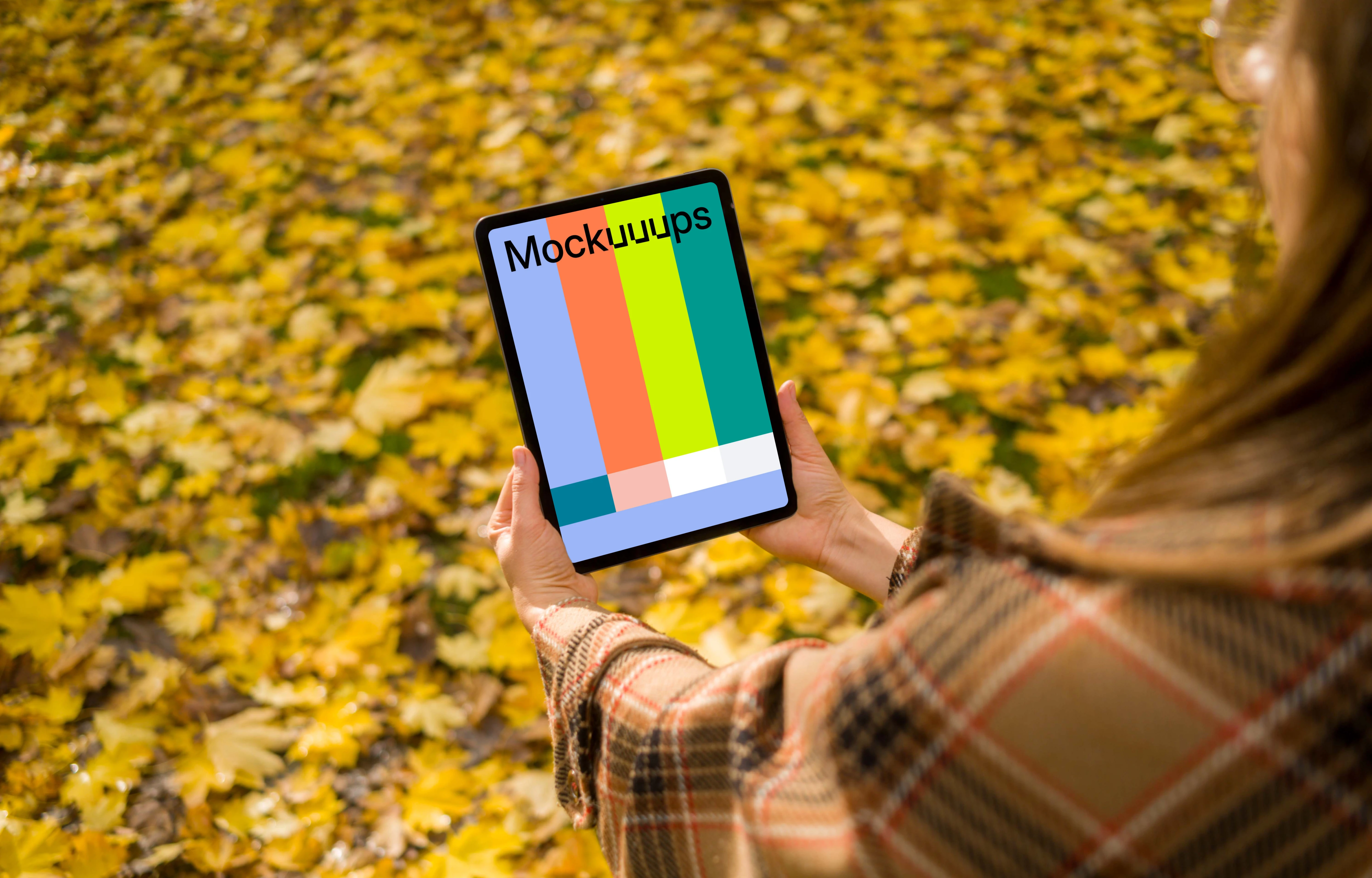 Woman holding an iPad Air in autumn vibe mockup
