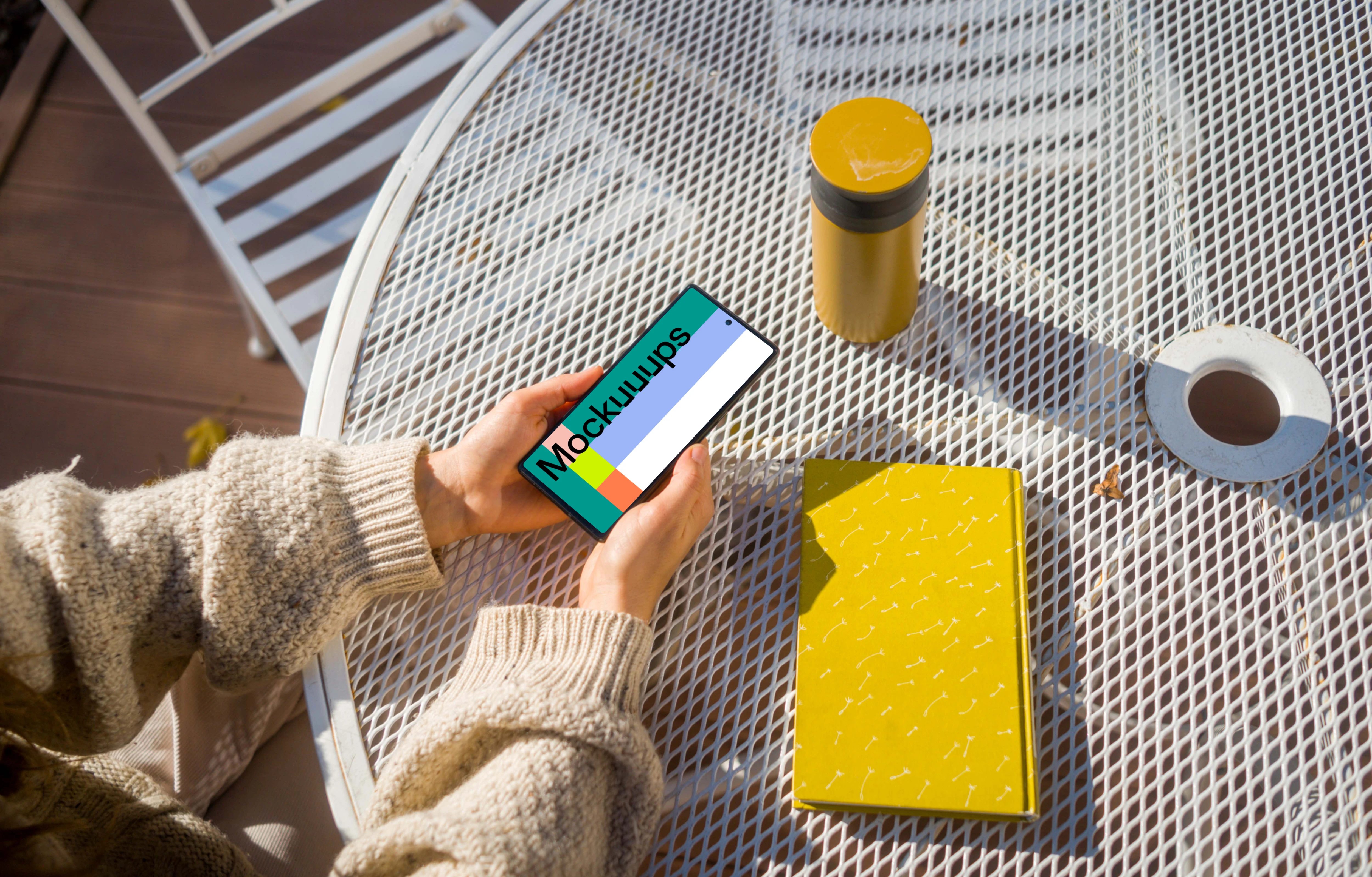 Woman holding a Google Pixel during autumn mockup