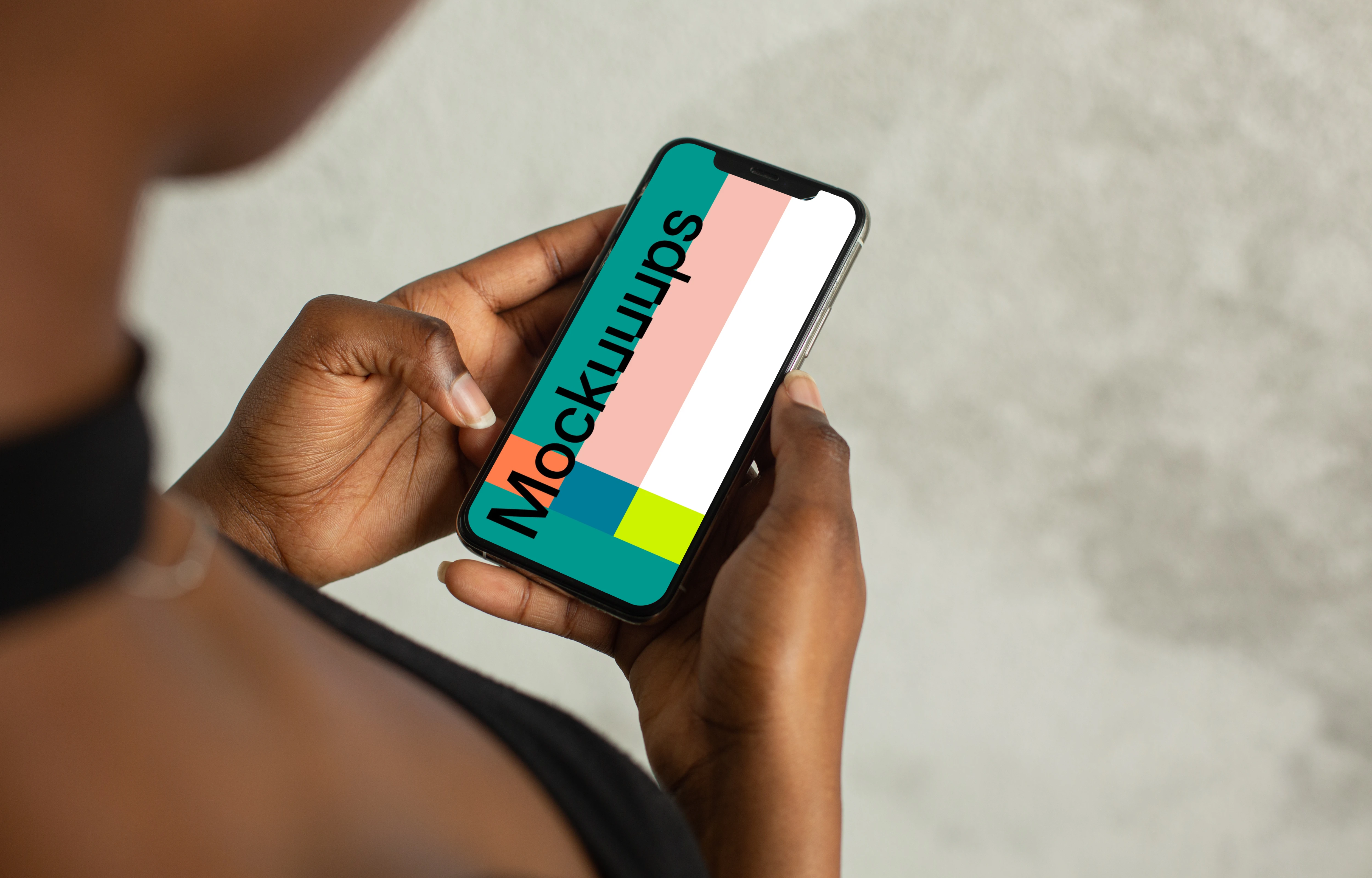 Young lady holding an iPhone 12 mockup