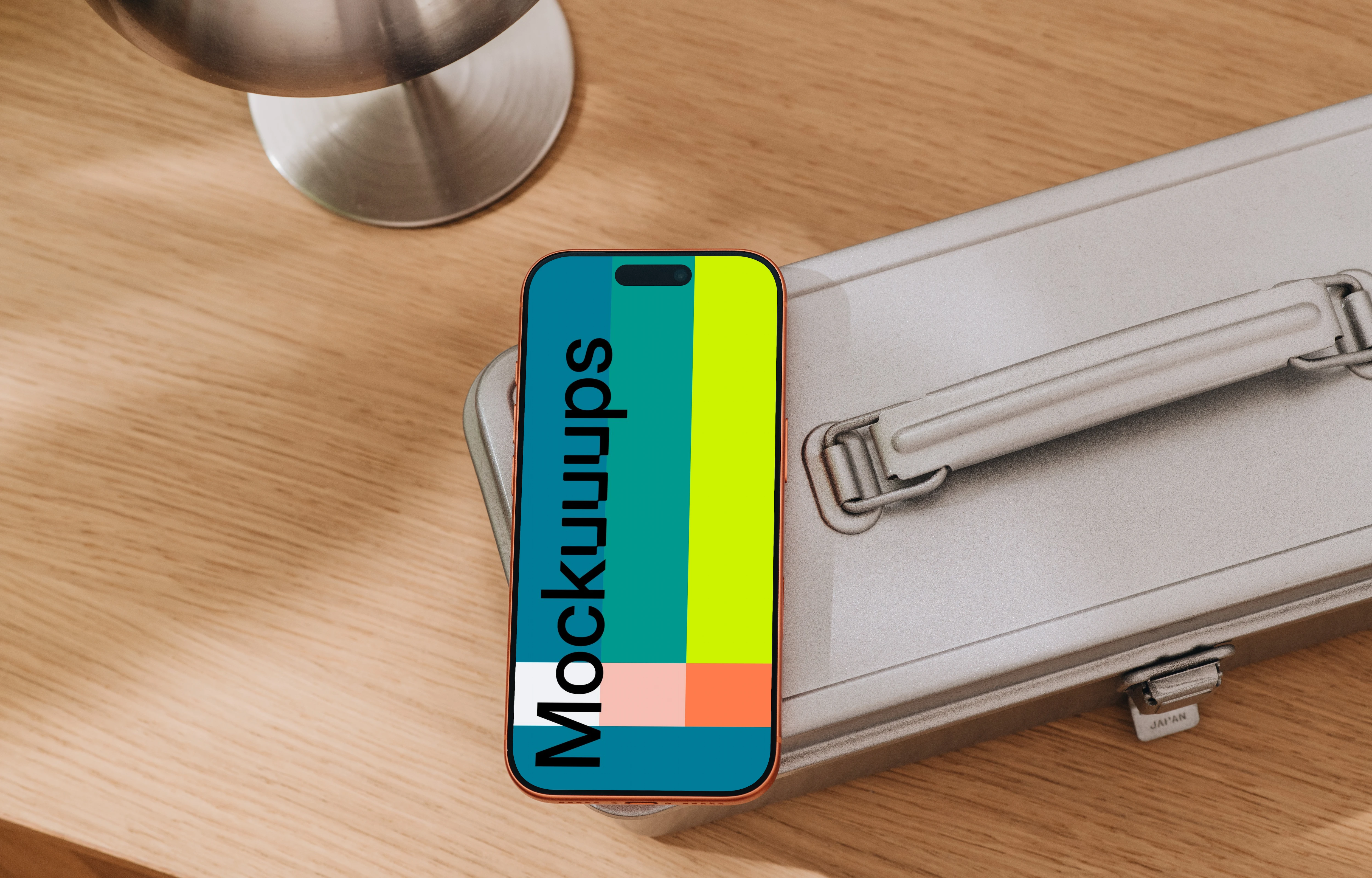 iPhone 17 Pro mockup on a metallic suitcase