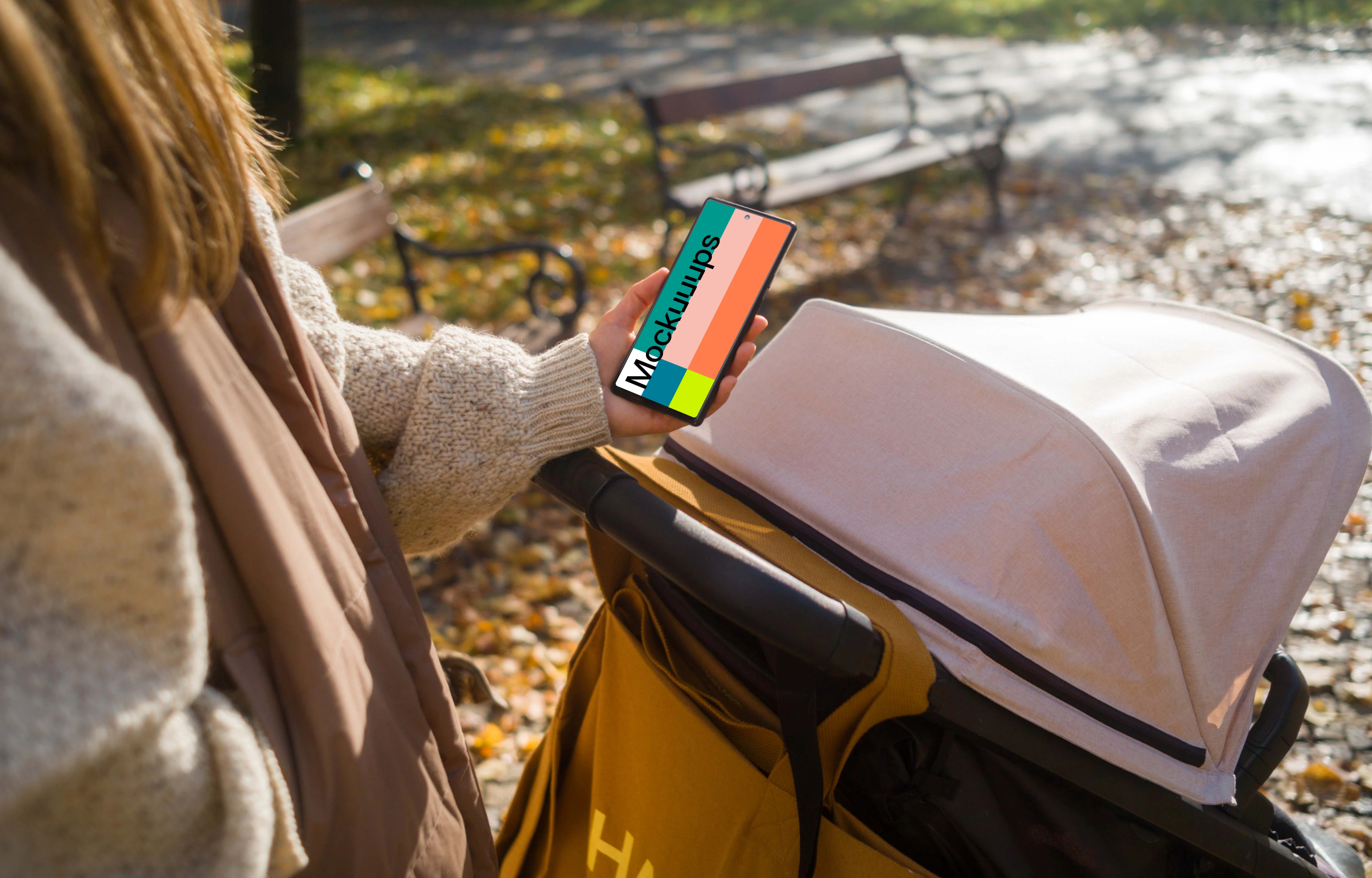 Female hand holding a Google Pixel 6 during autumn mockup