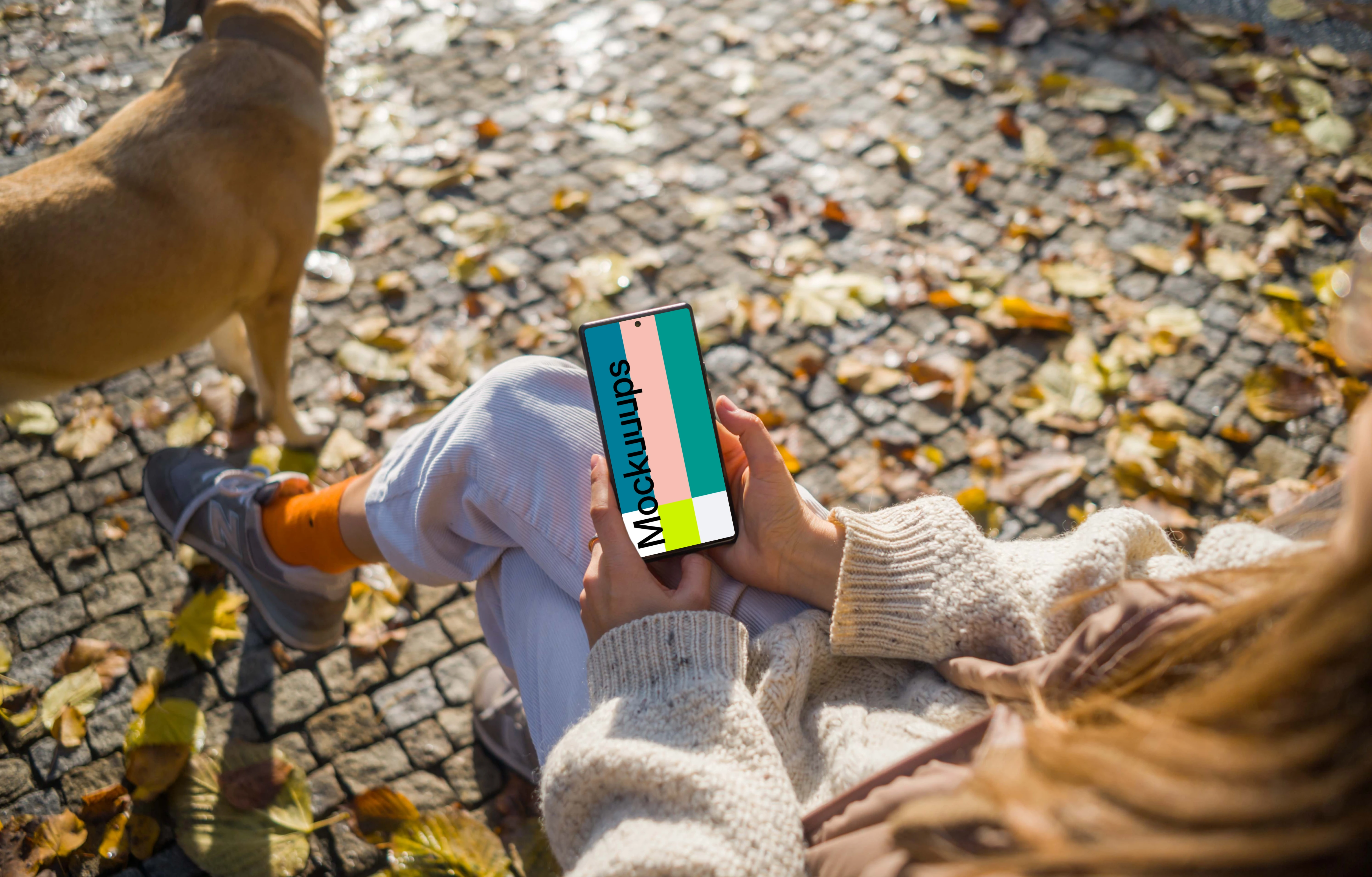 Female hands holding a Google Pixel 6 in autumn theme mockup