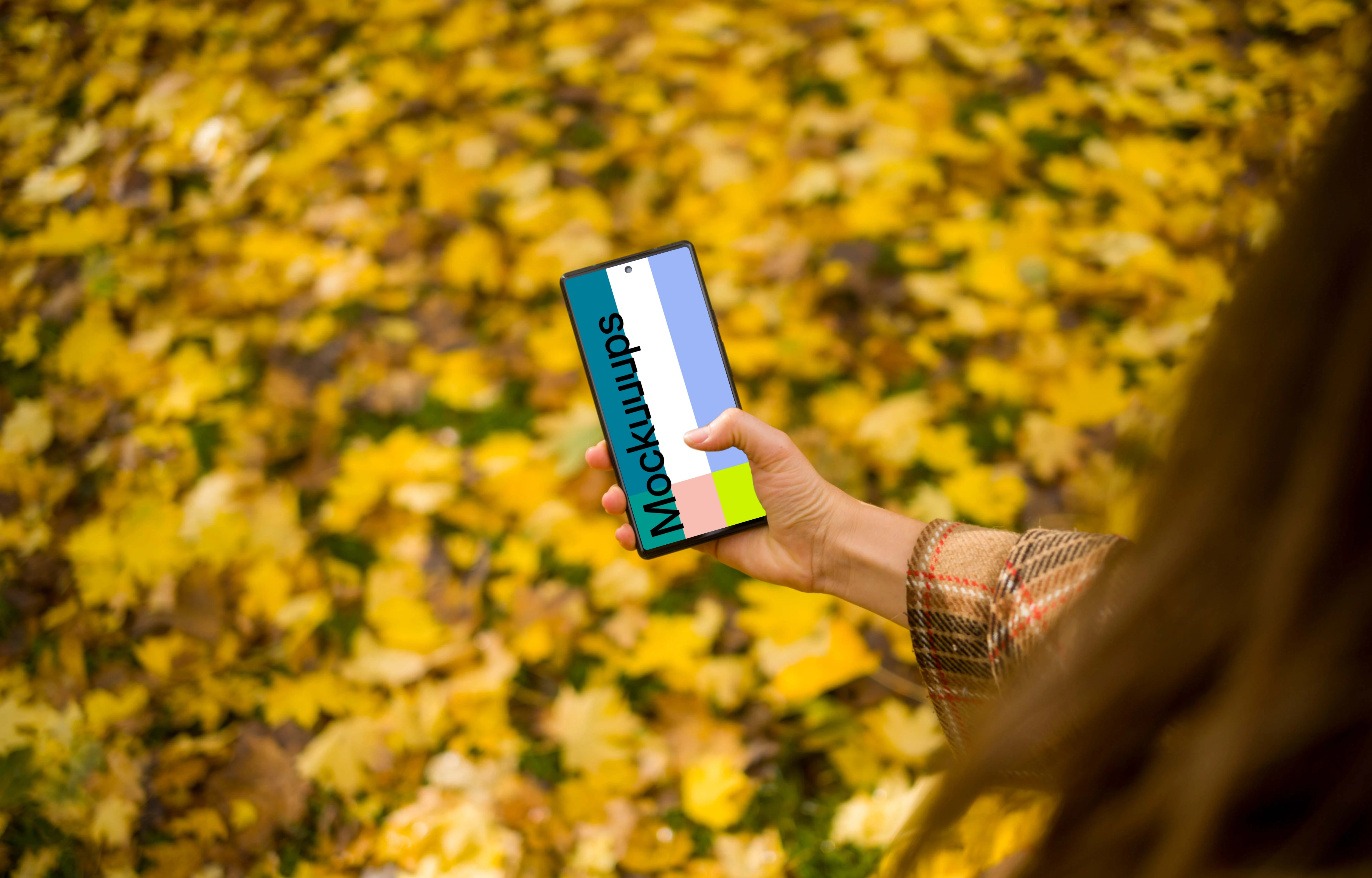 Hand scrolling on a Google Pixel 6 mockup in autumn theme